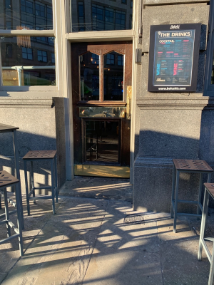 Door in the centre of the venue with one small step to access and short platform just before the door.