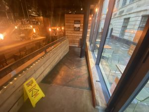 From the main entrance to the right is a gently sloping ramp which goes down then left to access the main restaurant. There is a large pillar on the right at the back which will obstruct.