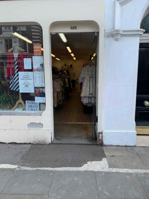 Door on the right of the space, vertical hand bar on the left, push to open (propped in photo). Displays straight ahead along the right wall and to the left in the centre of the space.