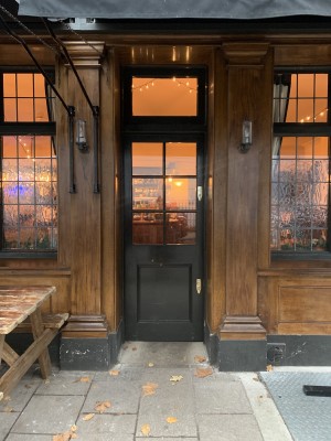 Door on the right side of the venue, push from the left to open. Inside bar ahead on the left along the back wall and seating left and right.