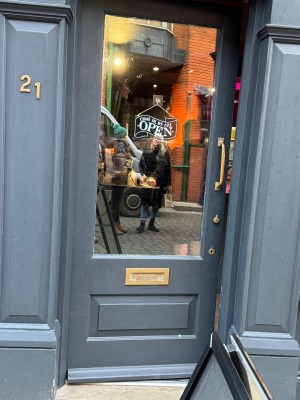 Main entrance. Door opens inwards from right to left, slight short ramp inside once entering.