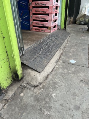 Steep, small ramp at the foot of the front entrance with lip at the top.
