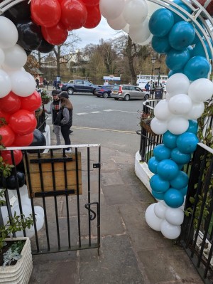 Gate before the entrance. Double gate but blocked by balloons and plant pots. Had to have a member of my party open the other side of the gate and squish the balloons back a bit