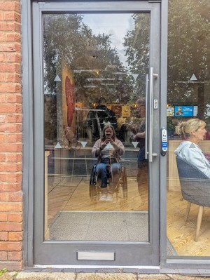 Ramped entrance glass door. Electric door opening to right of door.