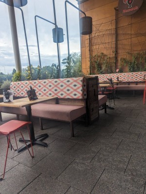Outside sitting area to the left of entrance.