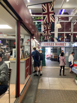 From market path, facing straight. Entrance to main area on left. Counter on back left.