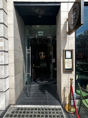 Main entrance. Step free access. On left and right of entrance, queue barriers.