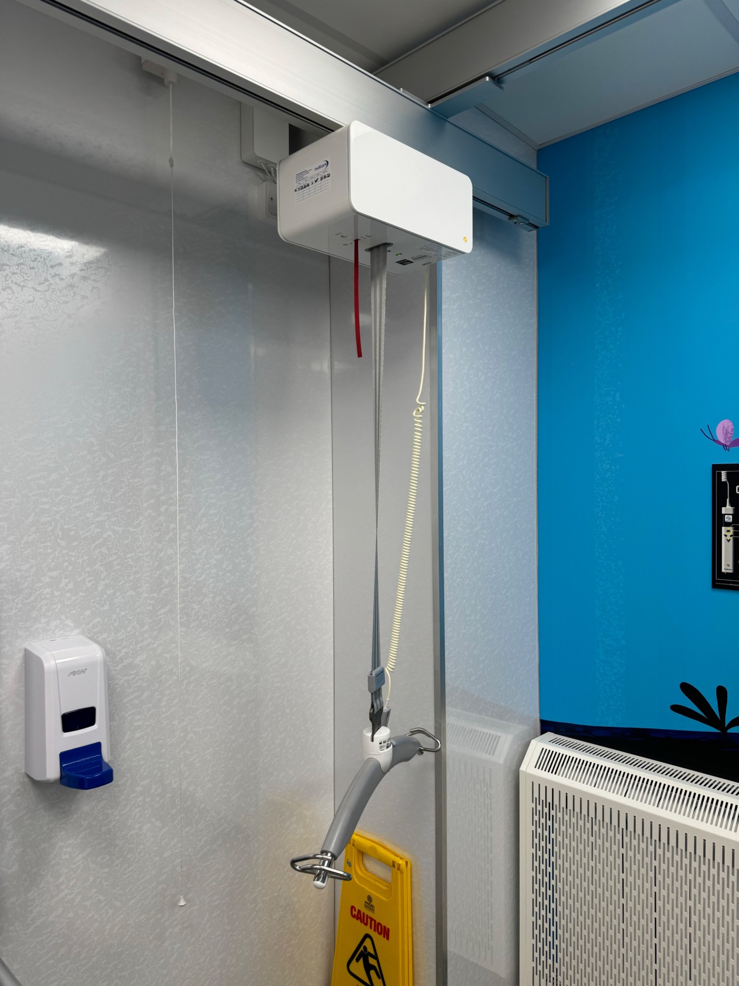 Ceiling track hoist lowered to wheelchair height