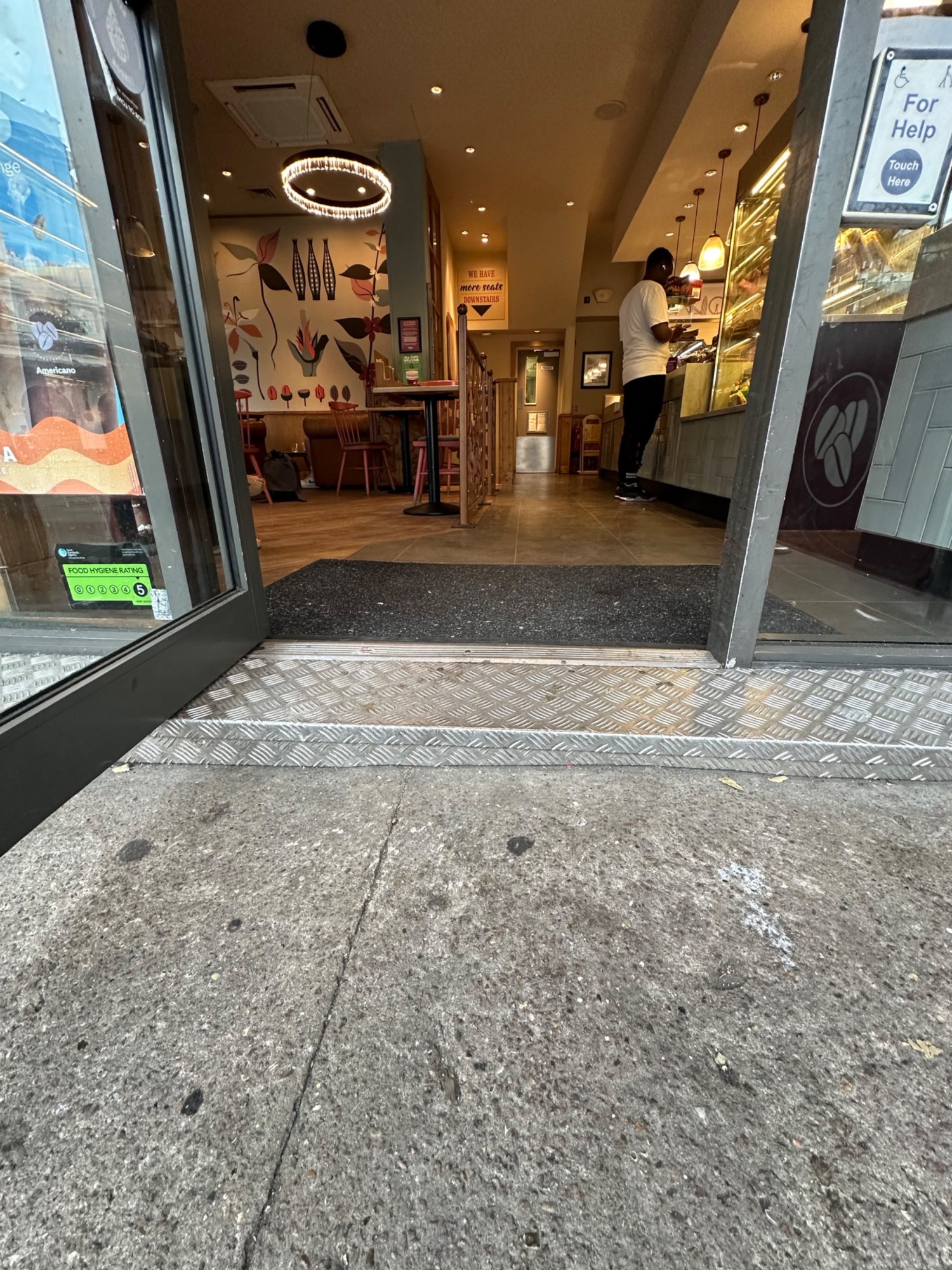 Step up before door. Small bump at foot of door followed by carpeted area.
