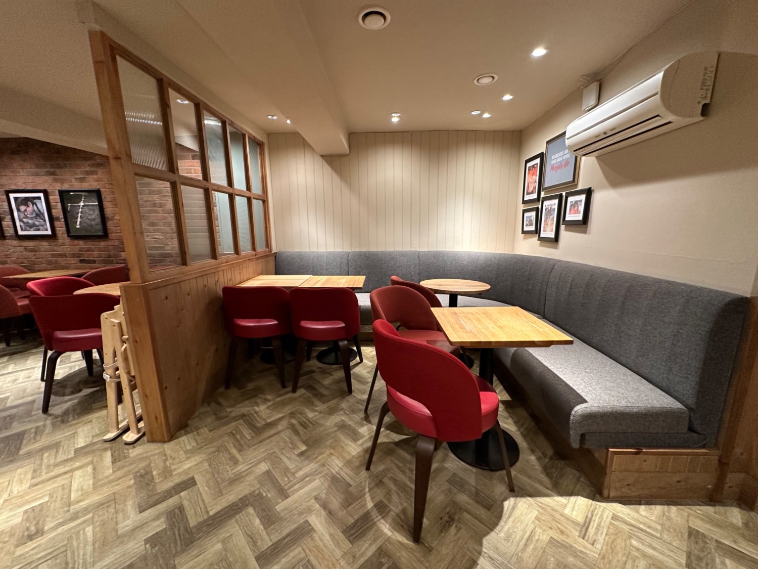 From after divider, facing left. Half booths with chairs ahead.
