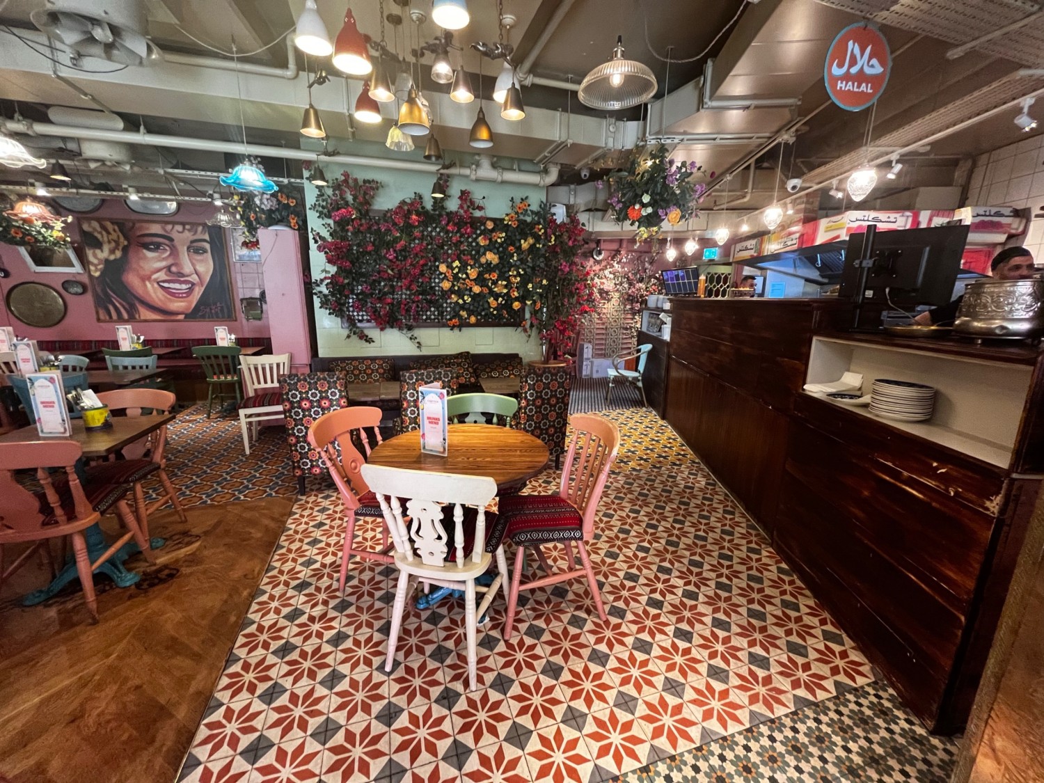 From plant facing straight. Chairs to the left and ahead. Path on right to toilet. Open kitchen along far right.