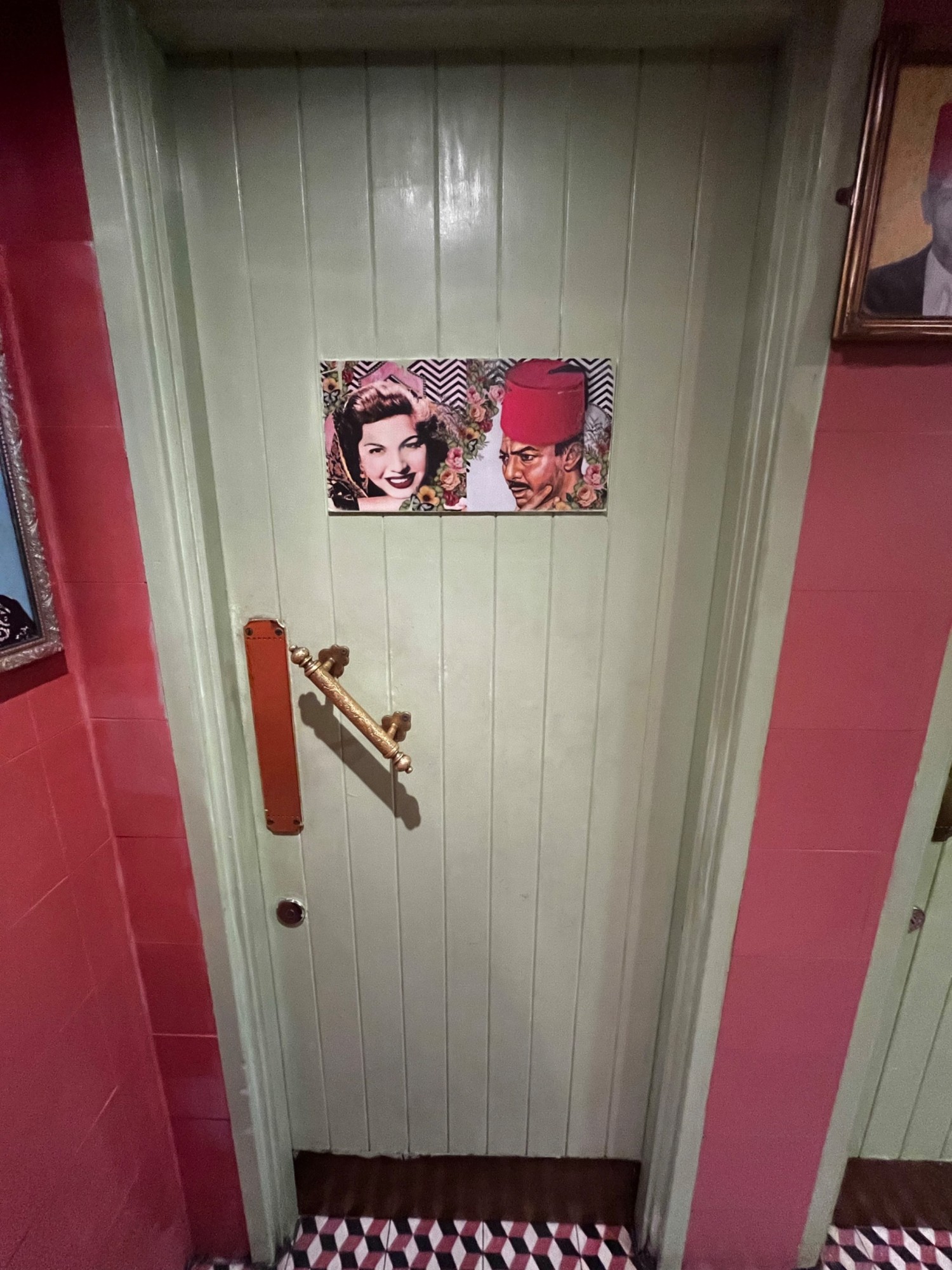 From toilet door facing straight. Push gold metal handle on left side of green to open.