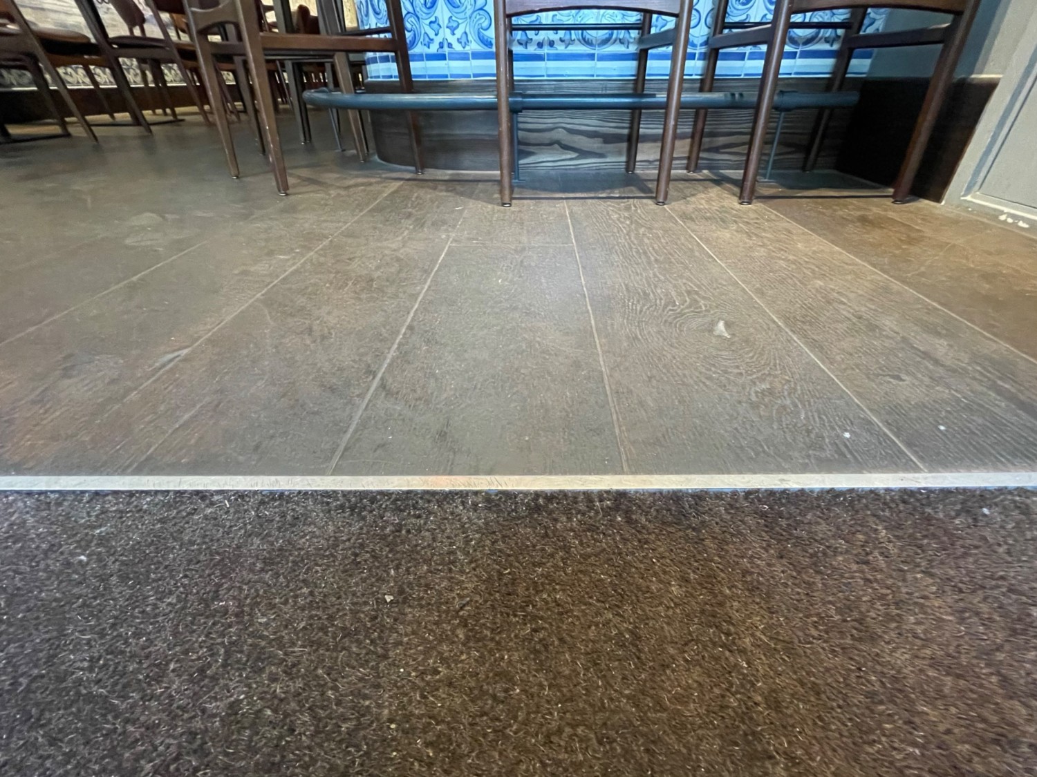 Third metal bump at end of carpeted area. Main area ahead.