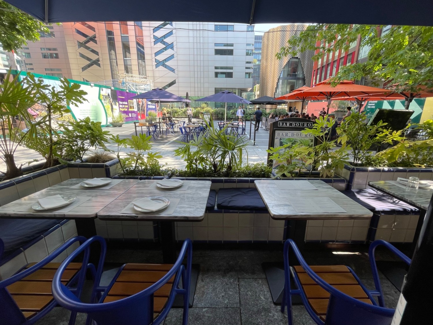 From umbrella, facing left. Half booth along back wall.