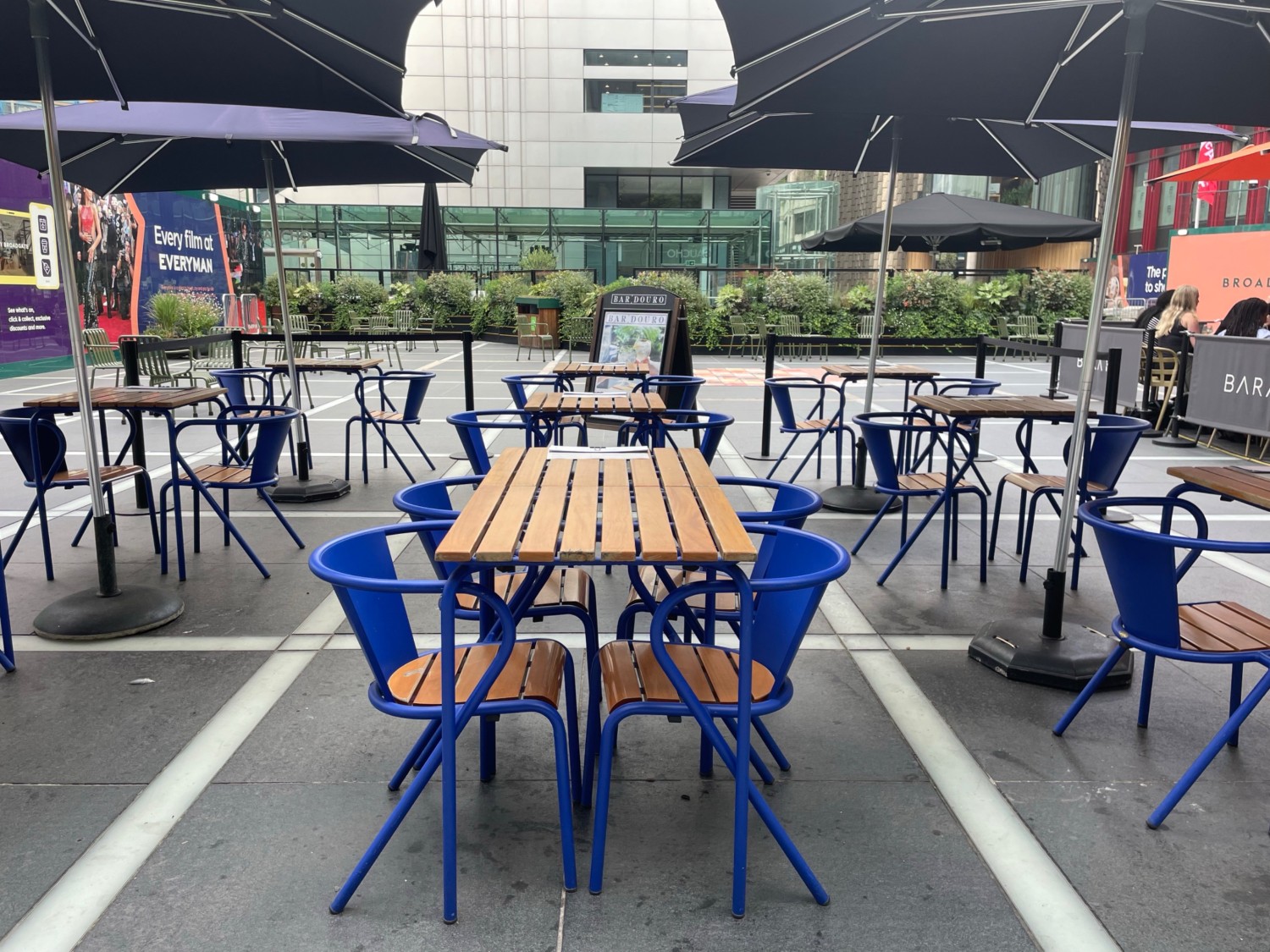 From end of path, facing straight. Tables and chairs spread out ahead.