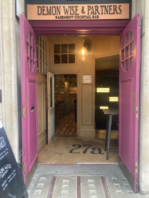 Double wooden door. Pull open via handles in center. High table after right door obstructing entrance.