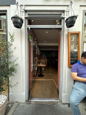 Glass door. Silver vertical handle on right, push to open.