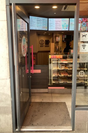 Glass door ahead with black frame ahead.