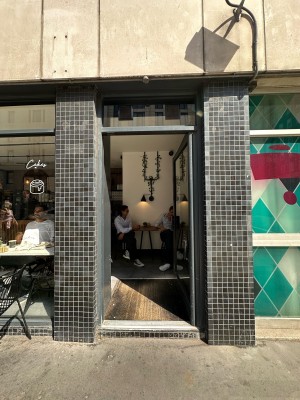 Glass door with grey frame. Grey handle on left, push to open.