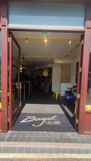 Glass doors with red frames ahead. Push gold handles in the centre to open.