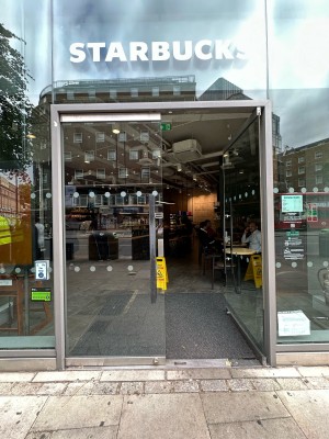 Glass doors with silver frame. Silver vertical handles in centre, push to open.