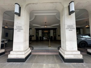 From pavement facing straight. Opening ahead. Pillars to left and right of it.