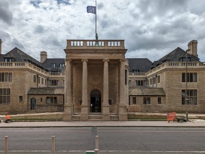 From street facing venue. Four large columns at front of venue with steps between leading to entrance. In built ramps to left and right side.