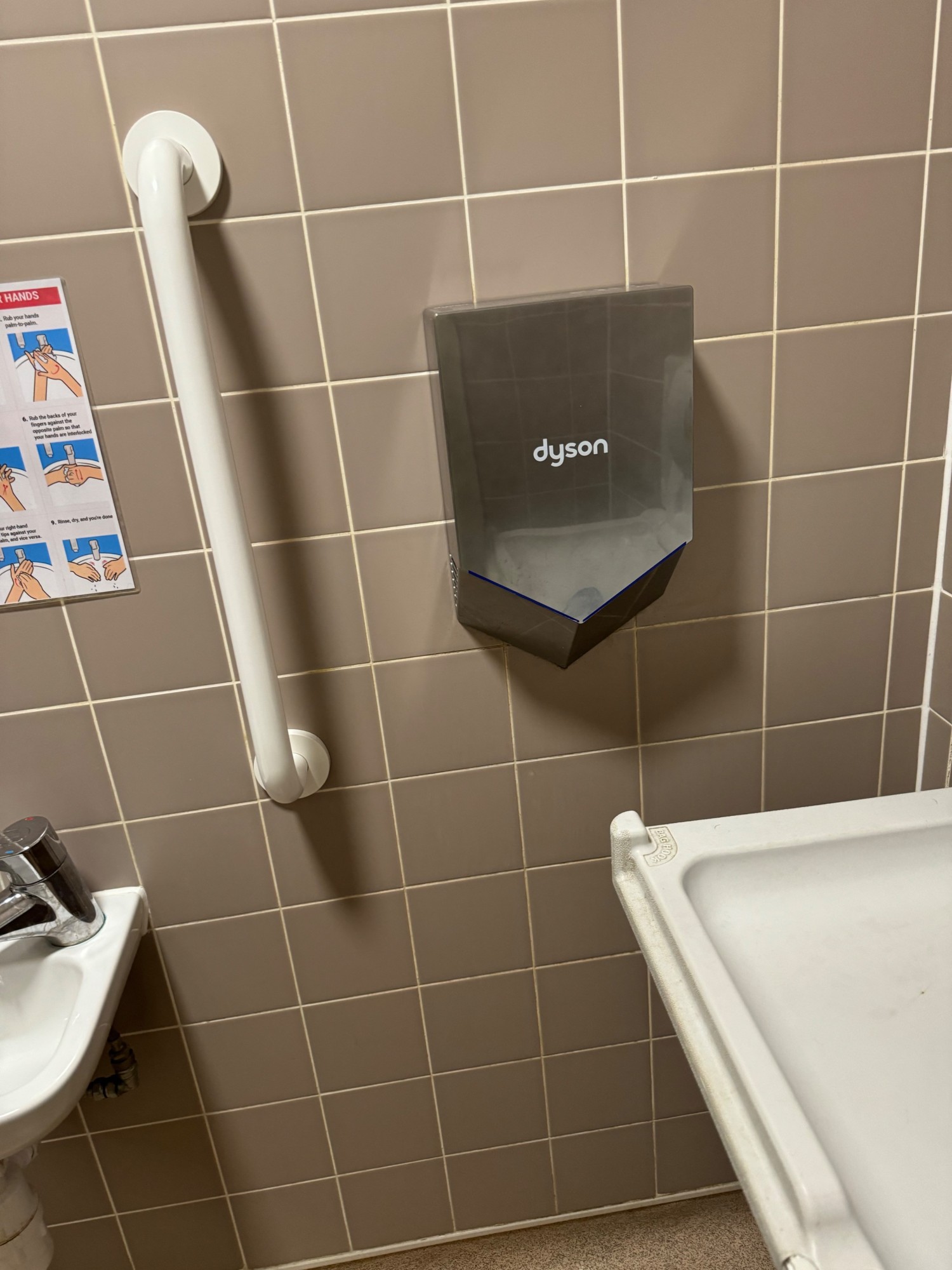 Hand dryer to the right of the sink