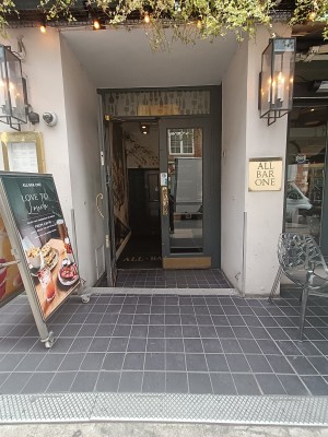 Glass doors with grey frame. Golden handle in middle. Pull to open.