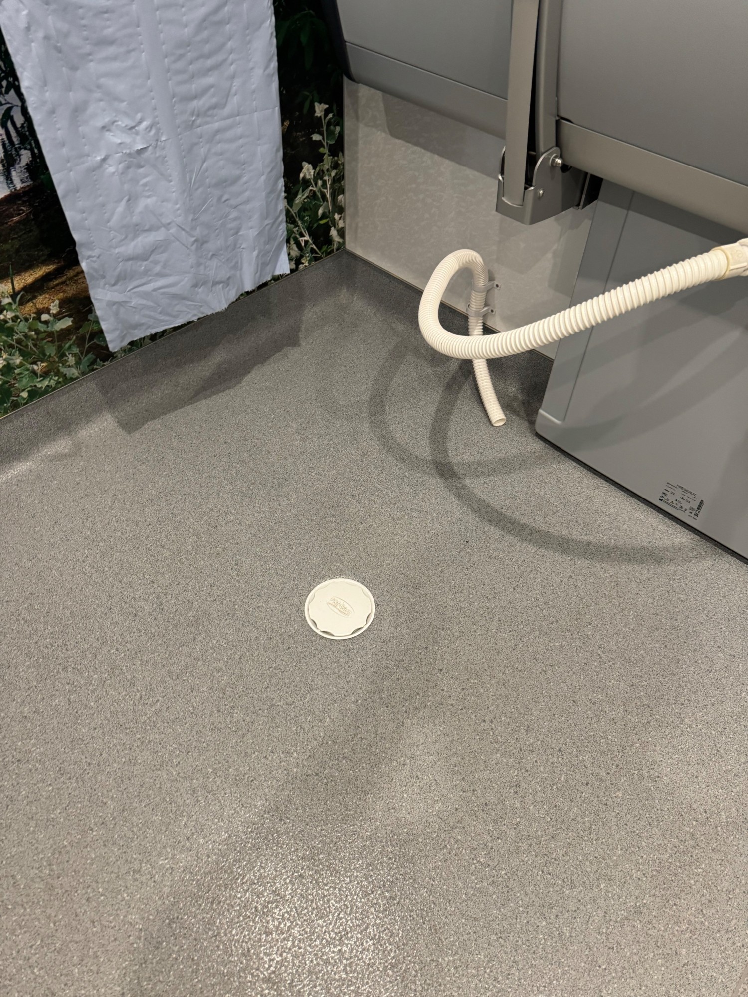 Drain in floor also drain tube connected to the changing bench