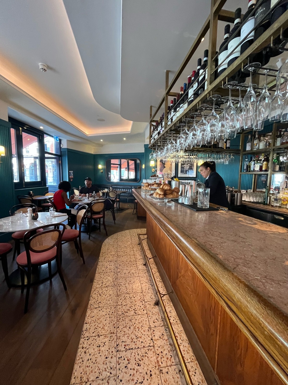 From bar facing straight. Path straight. Bar right. Tables and chairs left.