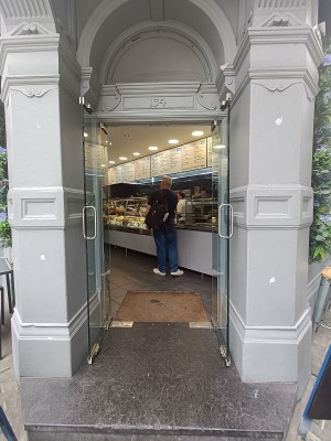 Glass doors with silver handle in middle. Pull to open.