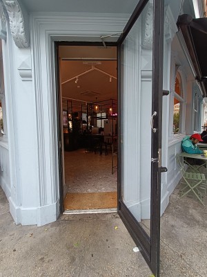 Glass door with black frame. Silver handle on left. Pull to open.