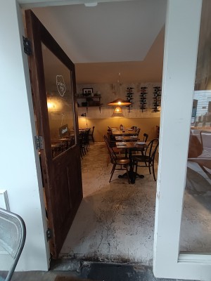 Glass door with wooden frame. Push from right to open.
