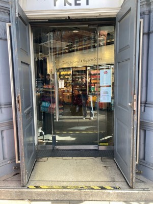 Access via glass door. Push open via vertical handrail on left.