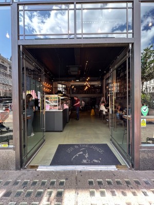 Double glass door. Push open via vertical brass handle in center.