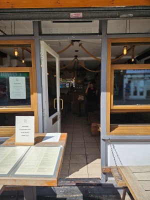 Glass door with woodframe with handle on the right side, opens inwards.