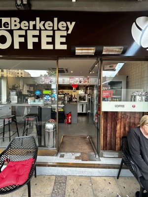 Single glass door ahead with silver handle on mid left. Push to open.