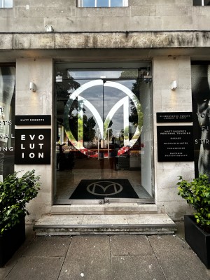 Main entrance double glass door with silver handles on middle. Push to open.