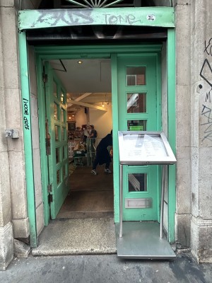 Double wooden door with silver handle on mid right. Push to open