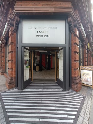 Glass doors with golden handles in middle. Push to open.