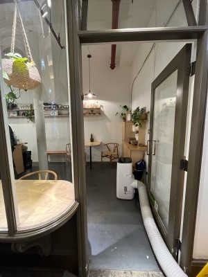 Single glass door in brown metal frame. Push silver metal handle from left to open.