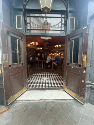 Wooden and glass doors ahead. Gold panel to centre. Pull to open from centre.