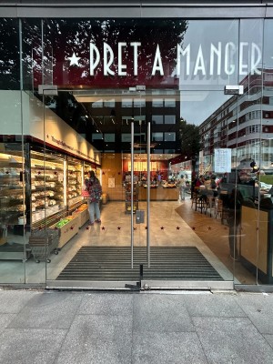 Glass doors with metal, silver, vertical handles in the middle. Pull to open.