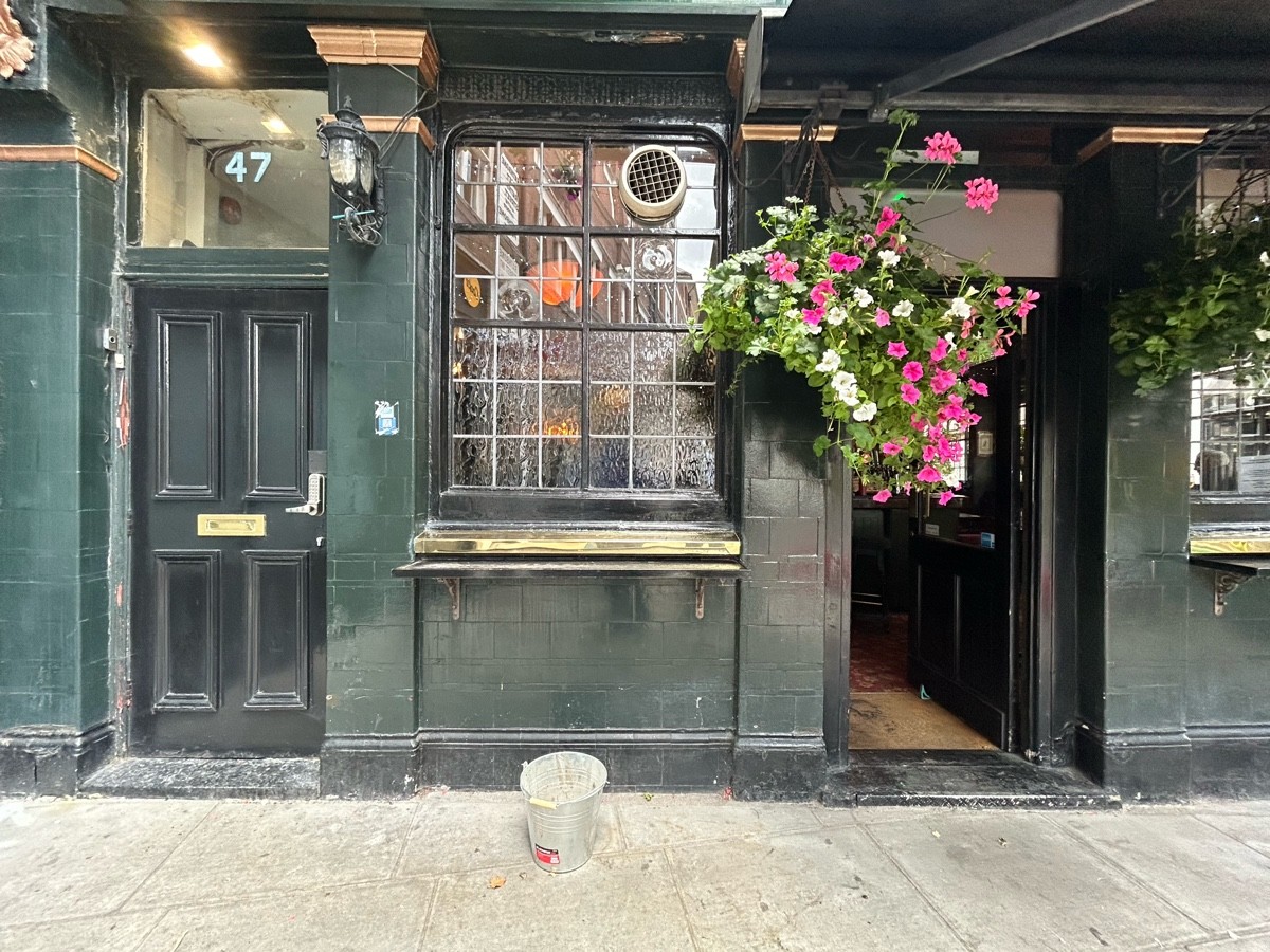 From left of alt entrance facing venue. High table along windowsill ahead.