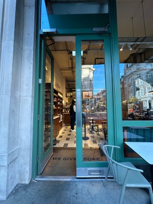 Glass doors with green frames. Silver pads in centre, push to open.