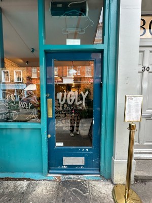 Dark blue and glass panelled door. Gold pad on left, push to open.