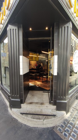 Two steps up to glass door. Pull via yellow handle on left to open.