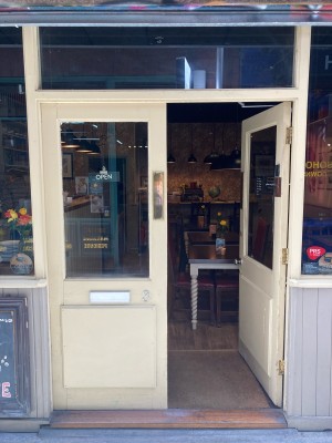 Access via double with white wooden door with glass panels. Push open via metal pads in center.