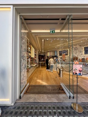 Glass doors with silver vertical handles in centre. Push to open.